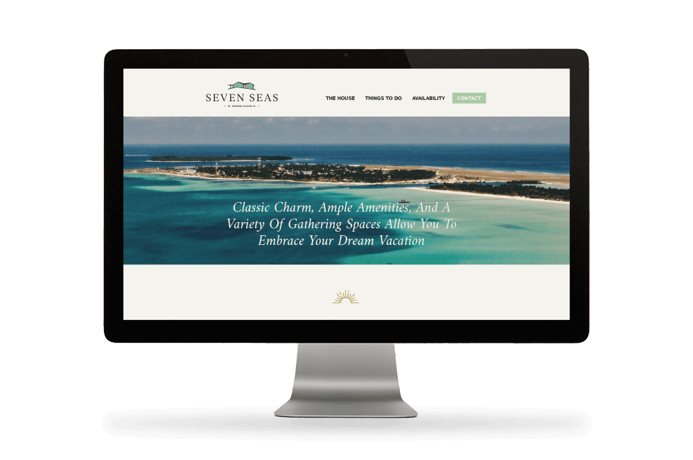 desktop monitor displaying Seven Seas website with landscape ocean image